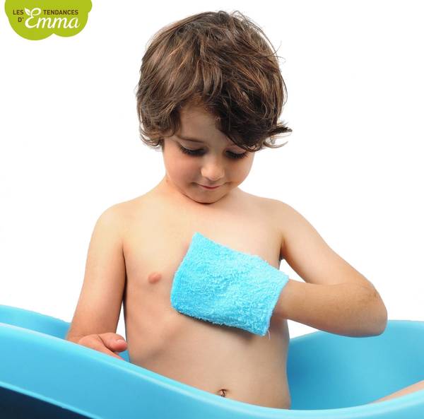 Enfant utilisant un gant de toilette bleu adapté à sa taille, idéal pour apprendre à se laver de manière autonome dans la salle de bain.